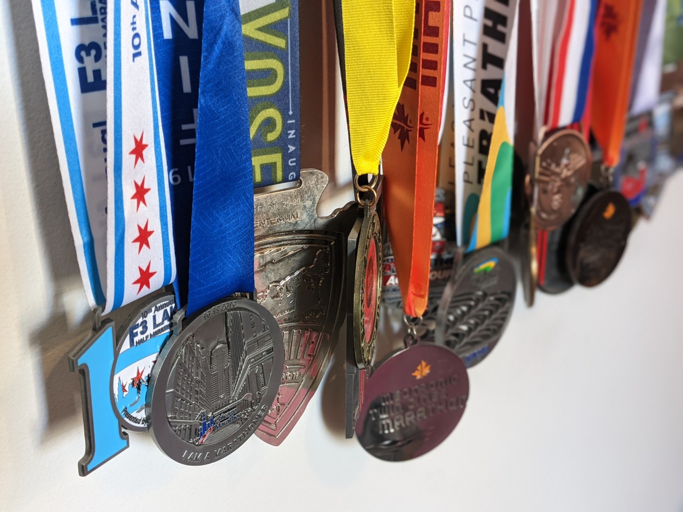 Race medals hanging on a wall.